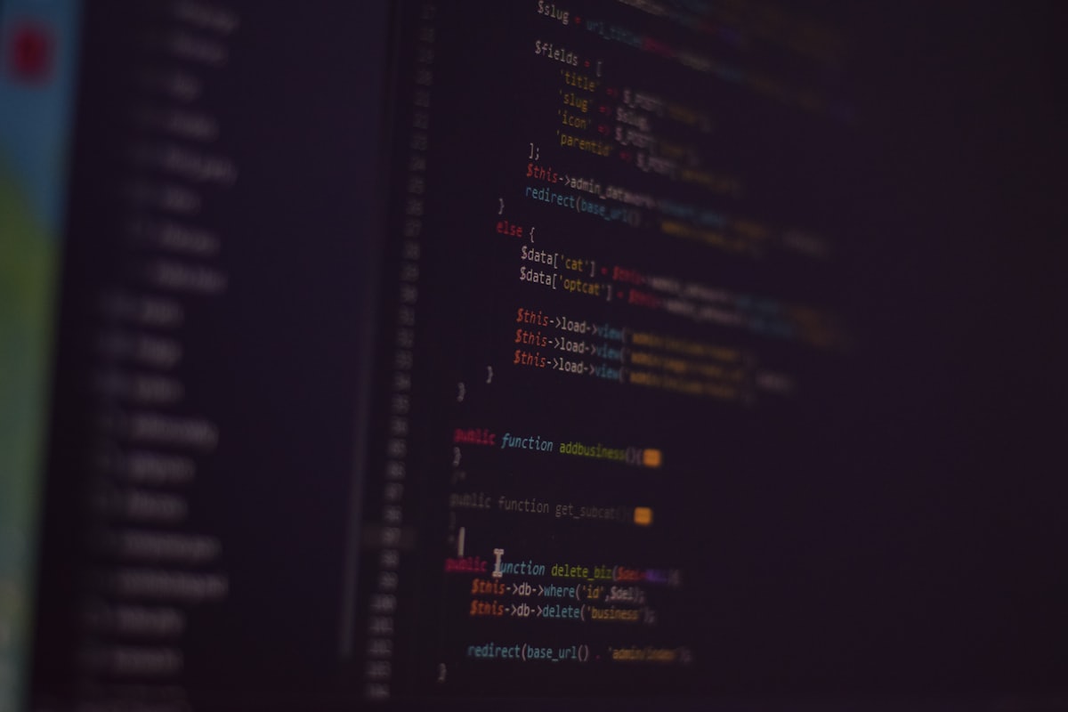 Close-up of colorful code on a screen in a dark room